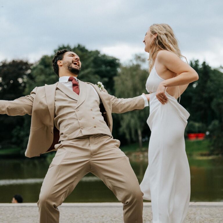 Bräutigam und Braut lachen, feiern und genießen ihre Hochzeitsfeier am See